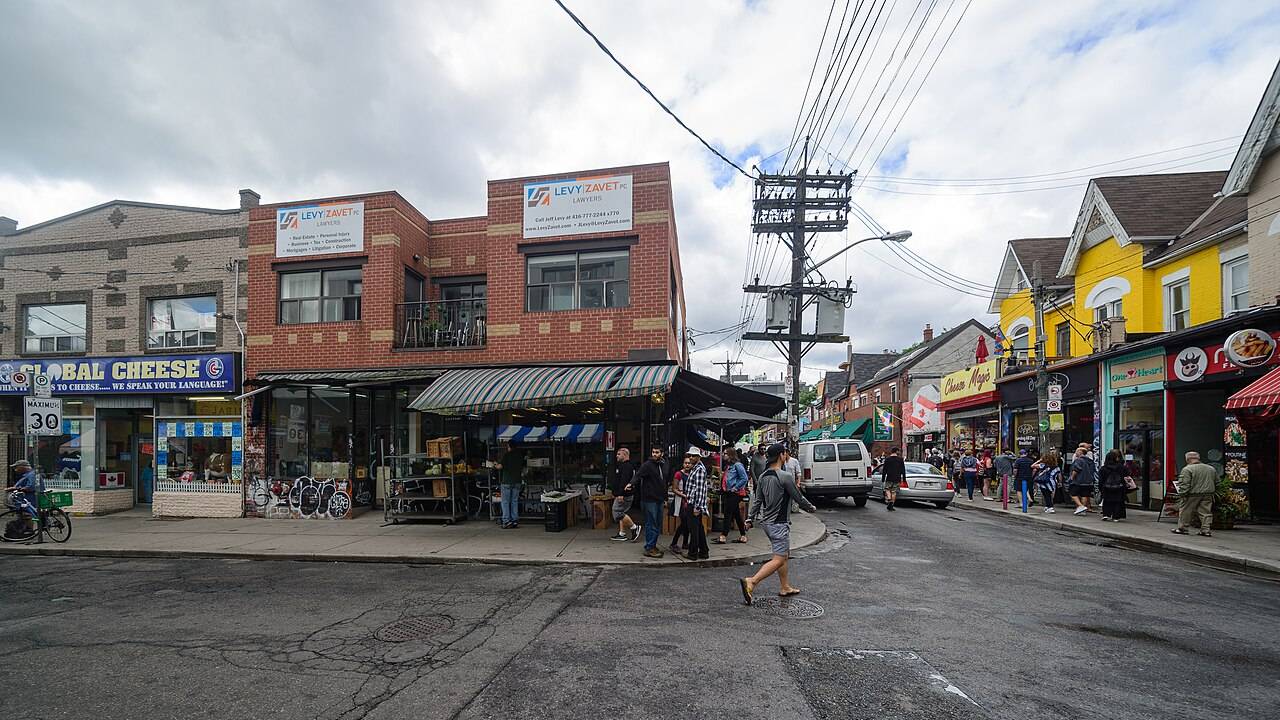 Colorful storefronts and street life on Augusta Avenue in Kensington Market, Toronto