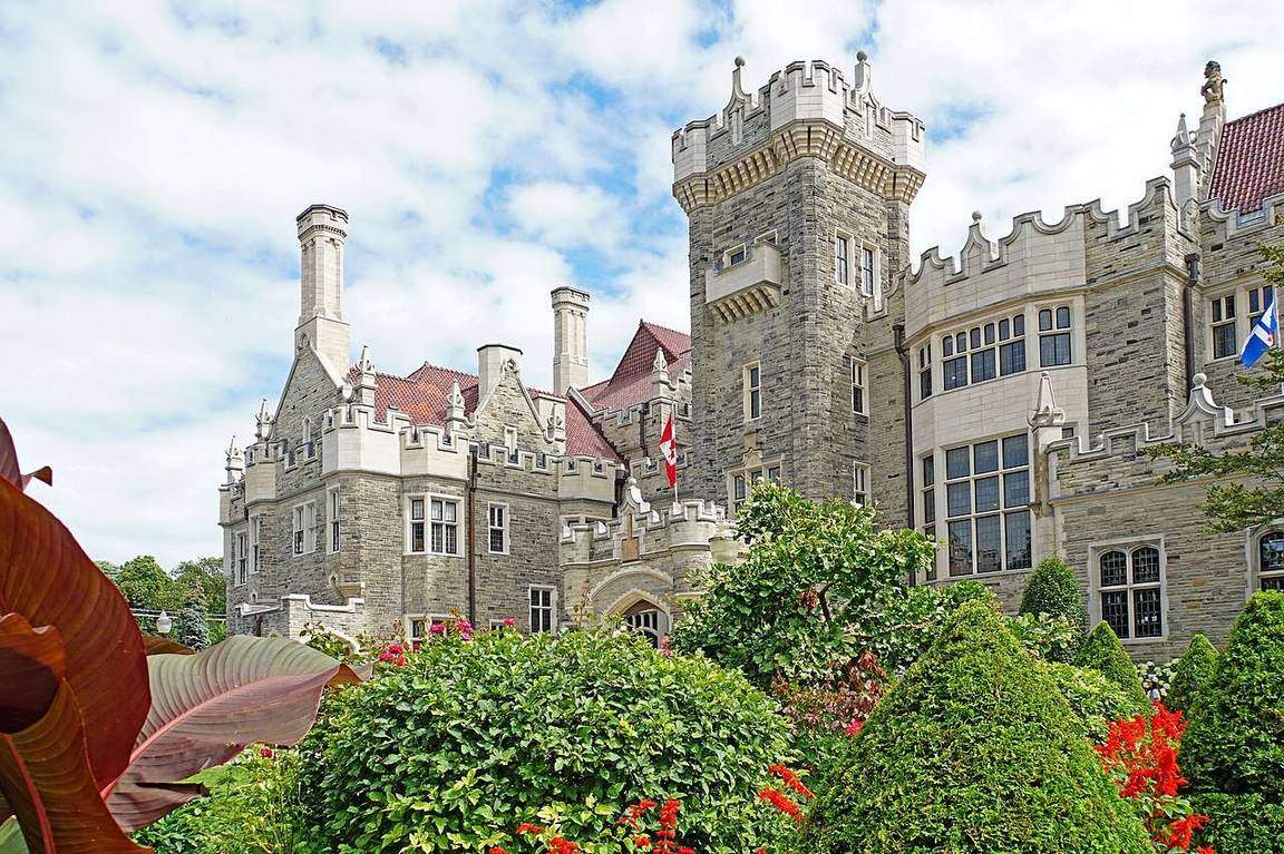 Gothic Revival towers and stonework of Casa Loma rising above its gardens in Toronto