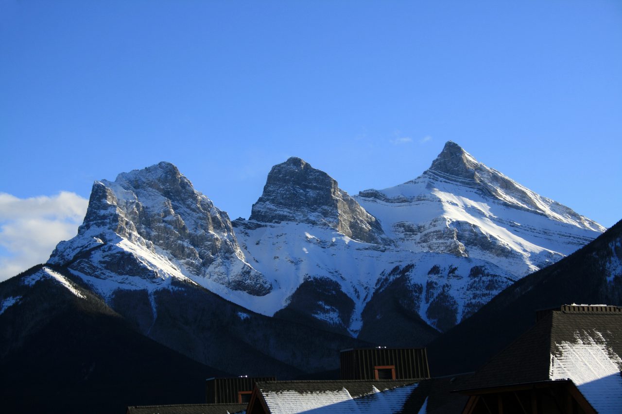 Three Sisters peaks rising above Canmore on a clear morning