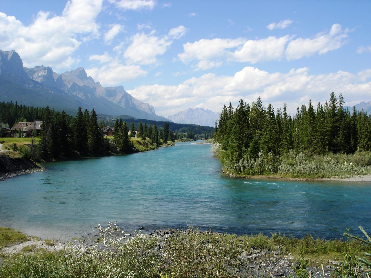 The Bow River flowing through Canmore with mountain views