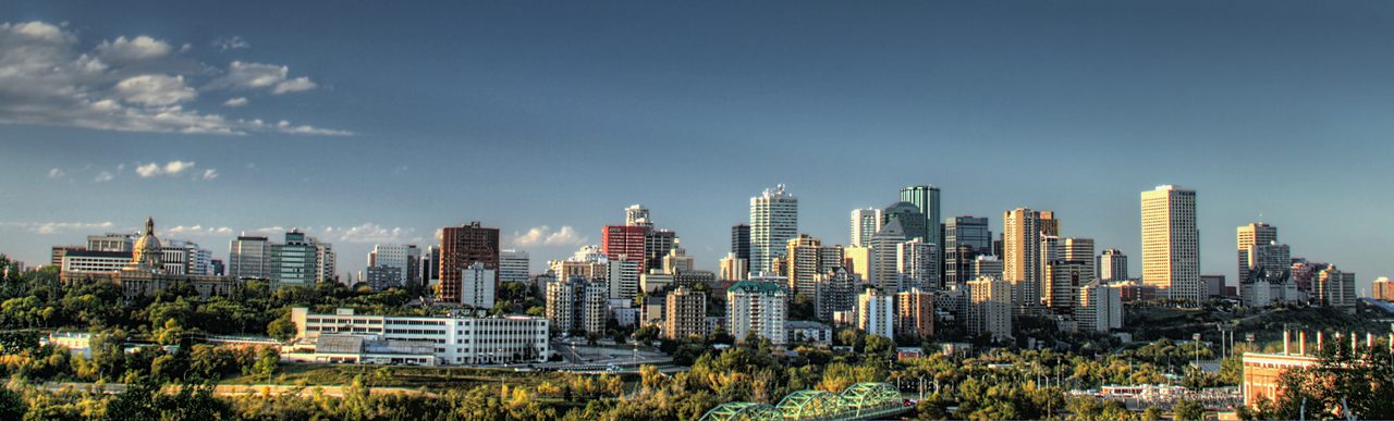 Downtown Edmonton skyline rising above the North Saskatchewan River Valley at dawn
