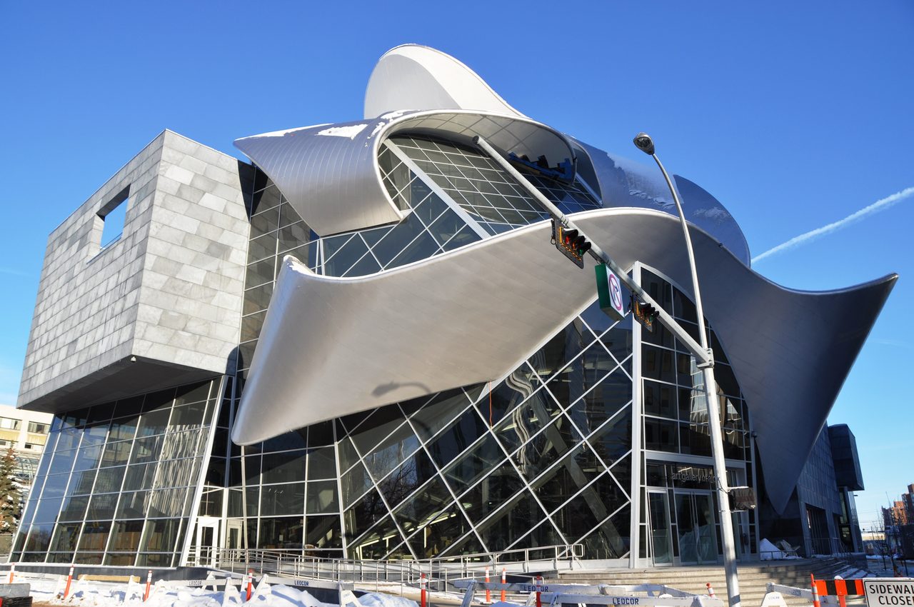 The curved glass exterior of the Art Gallery of Alberta on Churchill Square