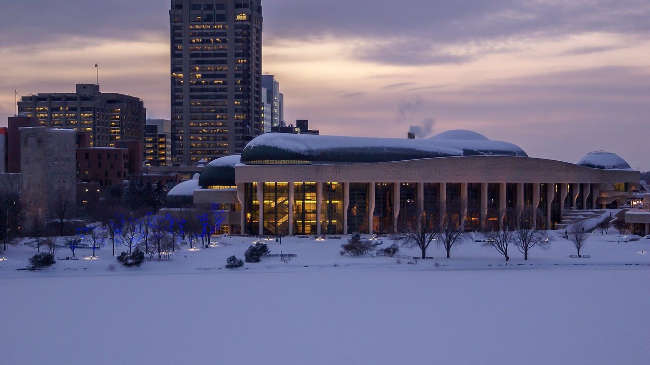 Curved limestone rooflines of the Canadian Museum of History rising above the Ottawa River in Gatineau