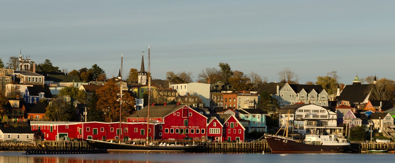 Colorful Lunenburg waterfront with the Fisheries Museum of the Atlantic and the tall masts of Bluenose II on the harbor
