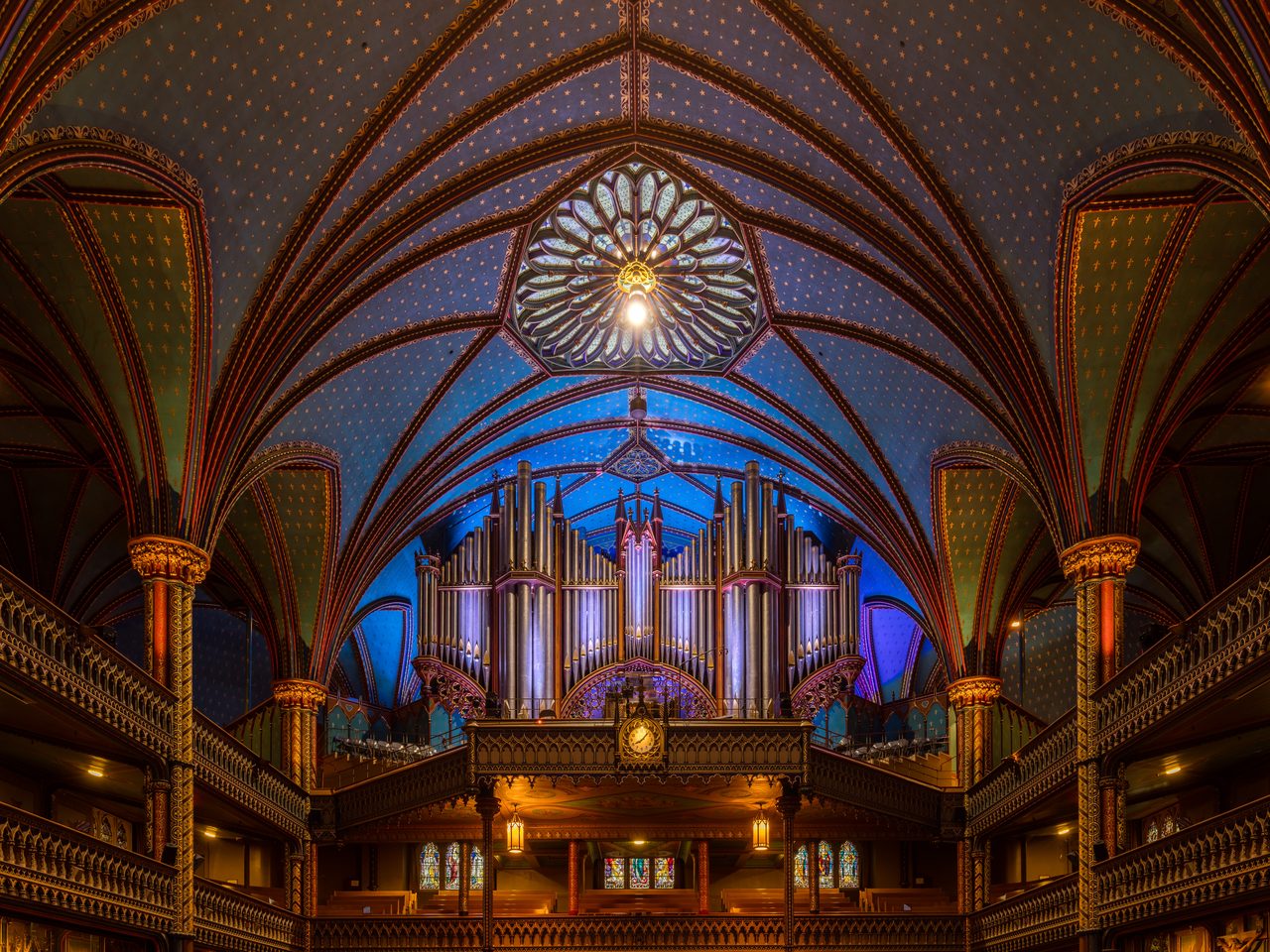 The deep-blue star-studded ceiling and ornate Gothic Revival interior of Notre-Dame Basilica
