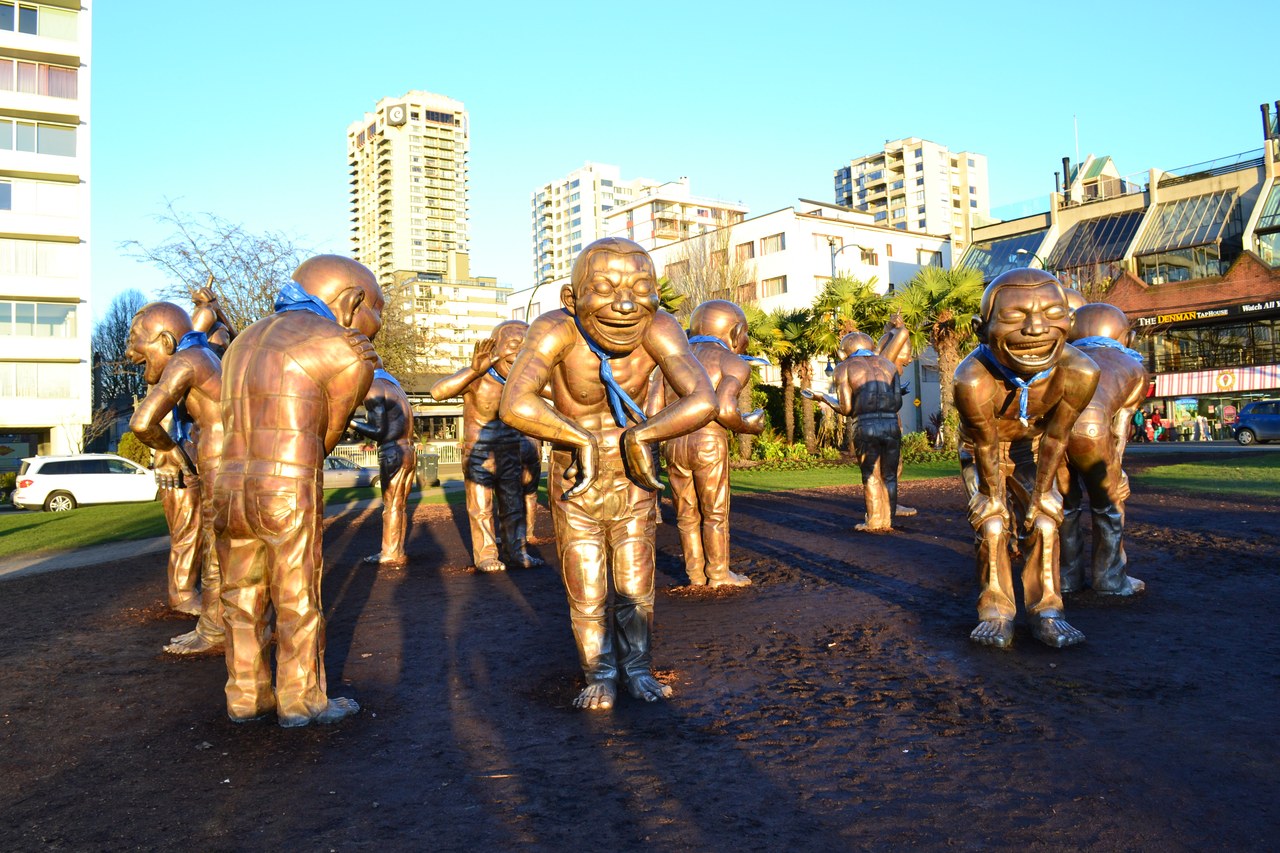The bronze A-maze-ing Laughter statues by Yue Minjun at English Bay