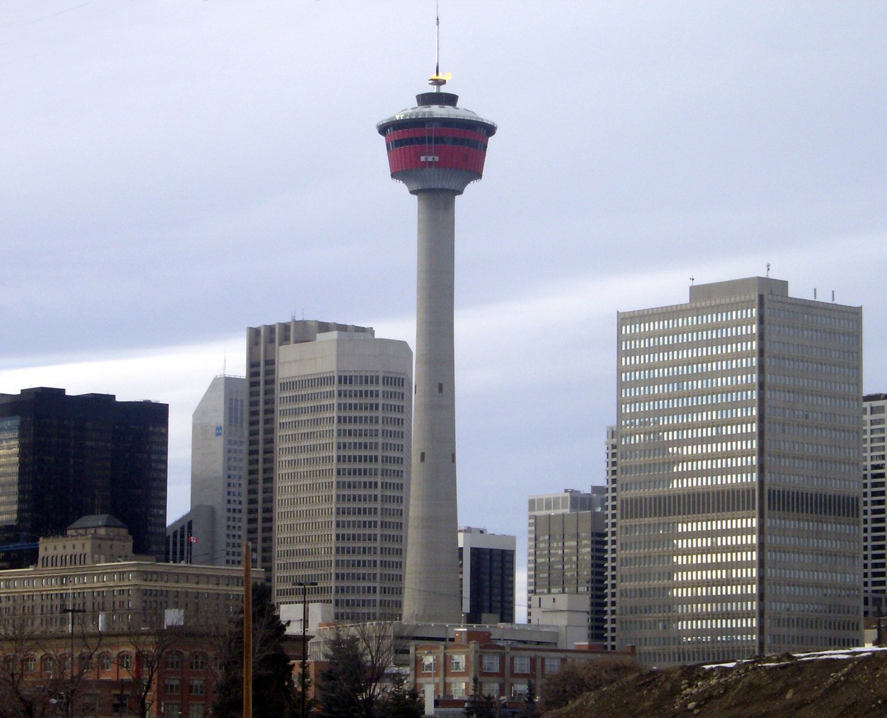The Calgary Tower with its Olympic cauldron flame lit above downtown