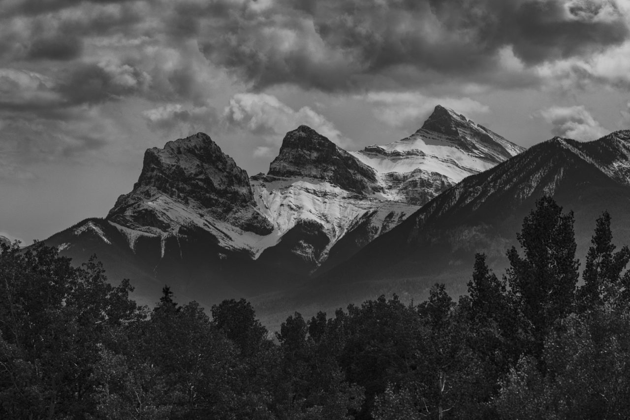 The Three Sisters peaks rising above the town of Canmore on a clear morning