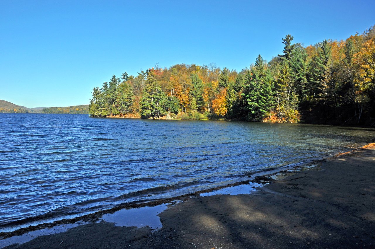 Lake Meech ringed with autumn forest in Gatineau Park near Chelsea