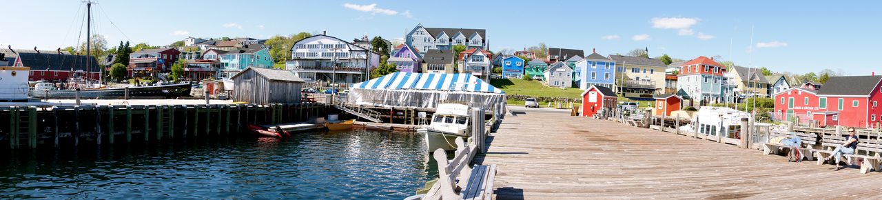 Panoramic view of Lunenburg's waterfront and brightly painted historic buildings on a clear summer day