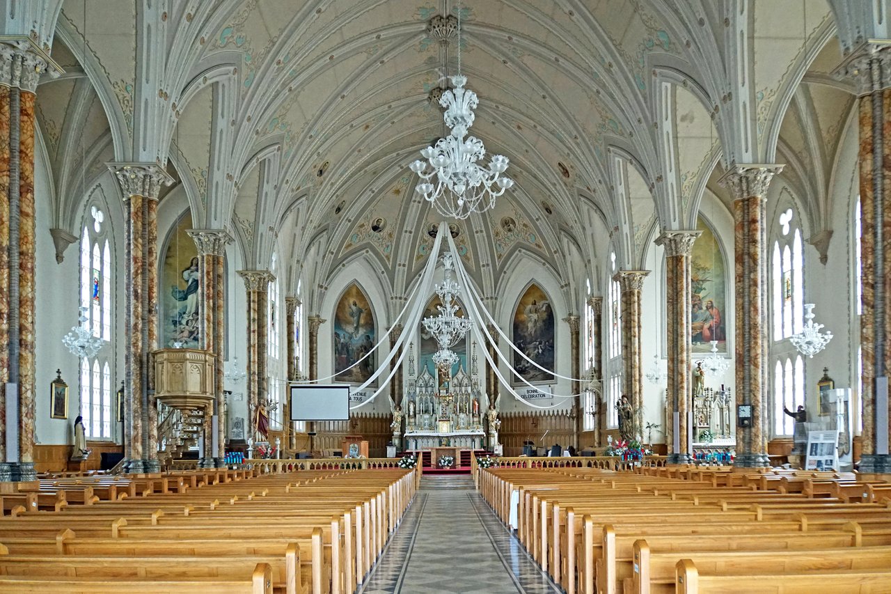 Blue star-painted ceiling and rows of wooden pews inside Notre-Dame Basilica of Montreal