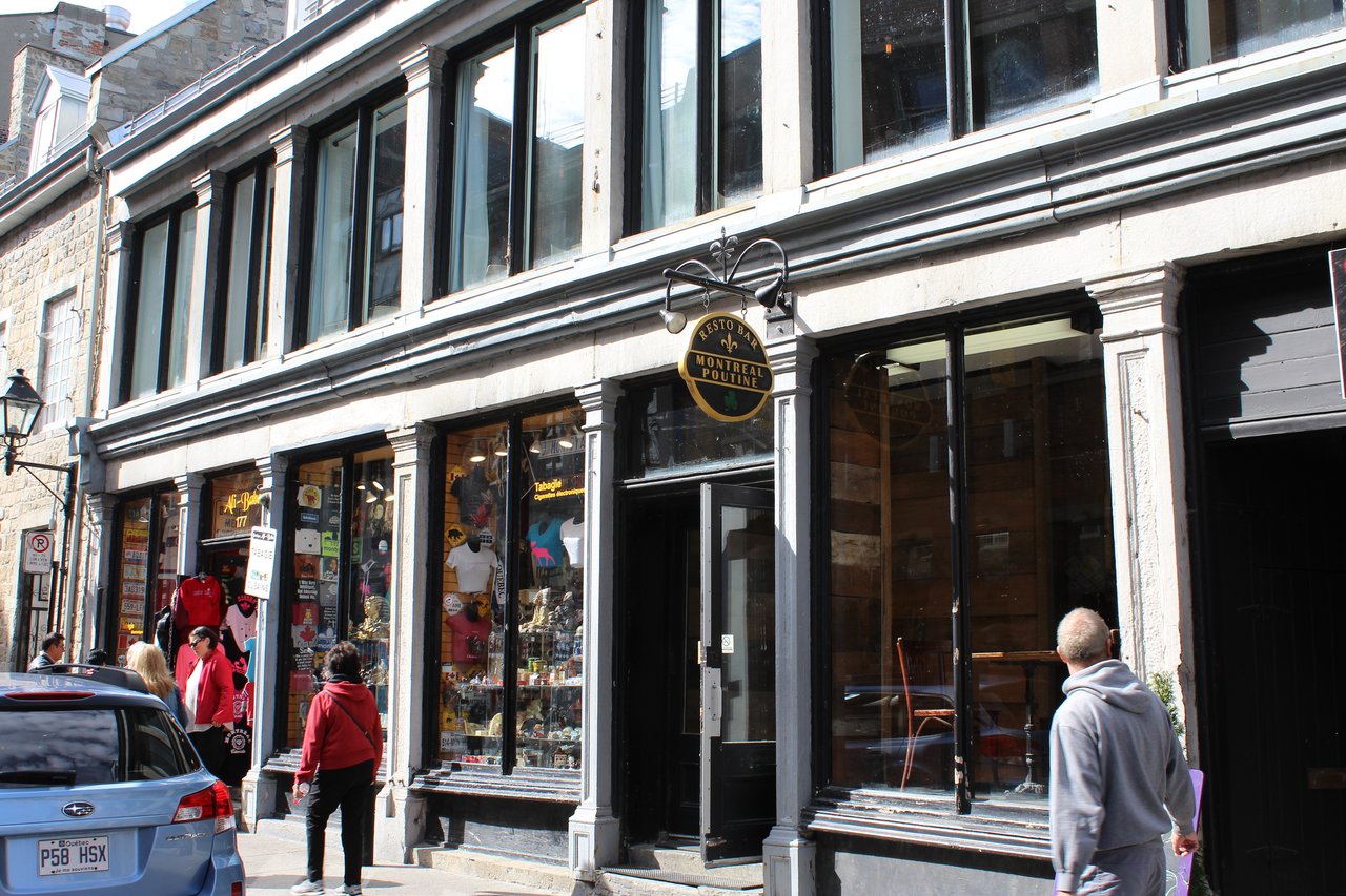 Stone storefronts and a poutine restaurant sign on Rue Saint-Paul in Old Montreal