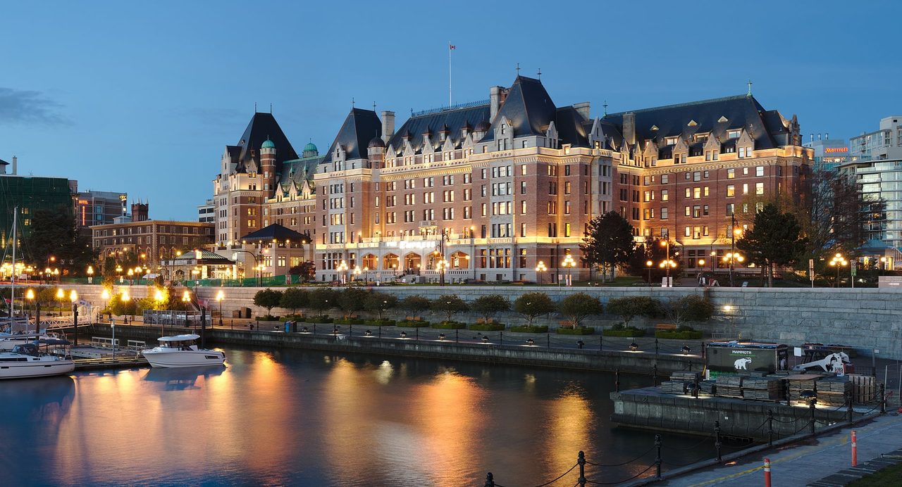 The Fairmont Empress hotel glowing during blue hour on Victoria's Inner Harbour