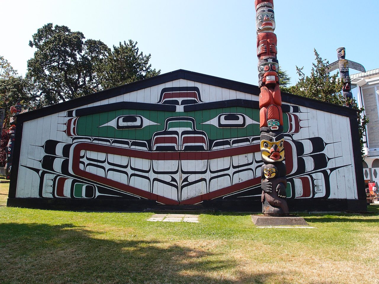 Totem poles standing tall at Thunderbird Park beside the Royal BC Museum