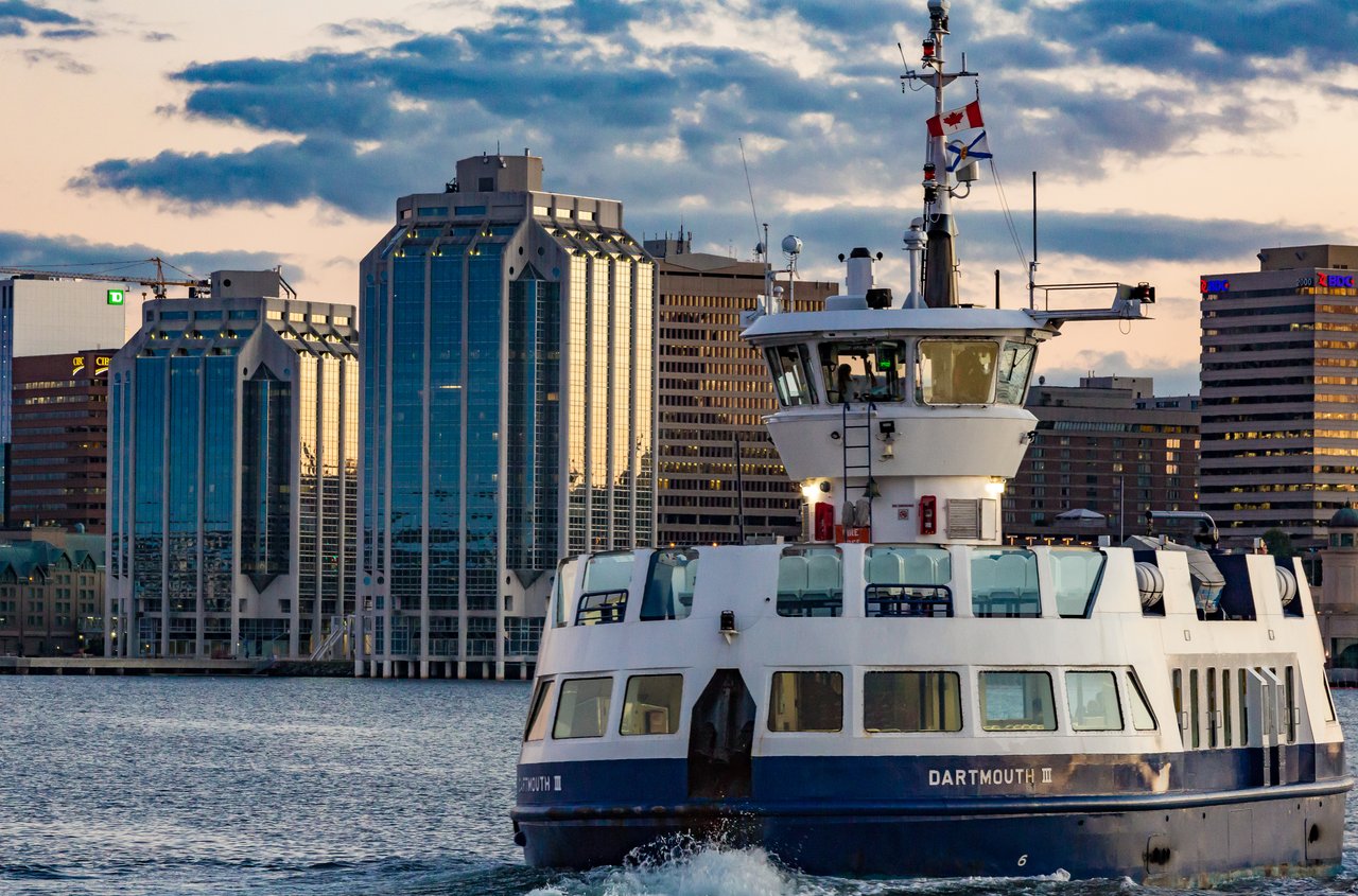 Halifax-Dartmouth ferry crossing the harbour at sunset with the downtown Halifax skyline behind it
