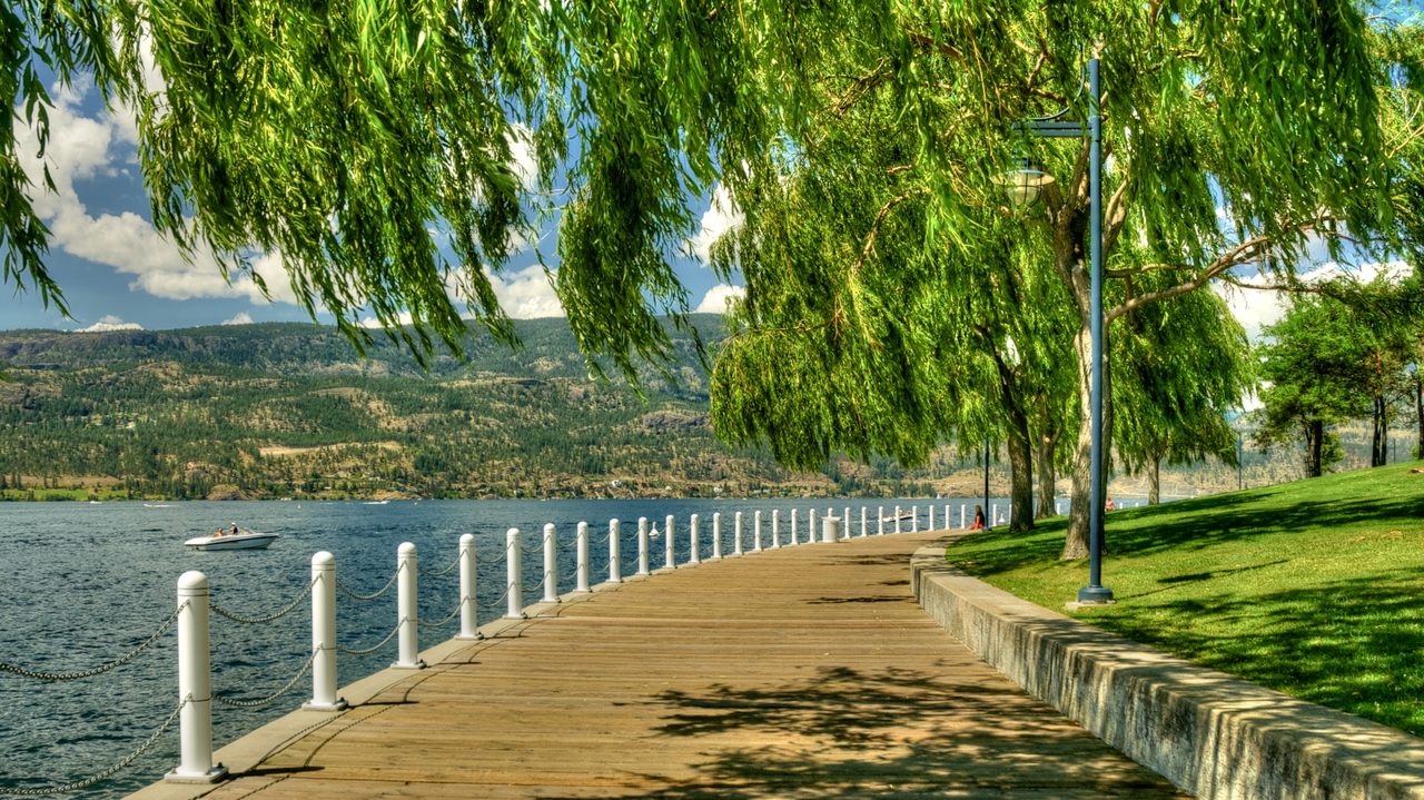 Lakeside path through Waterfront Park in Kelowna with trees and the lake beyond