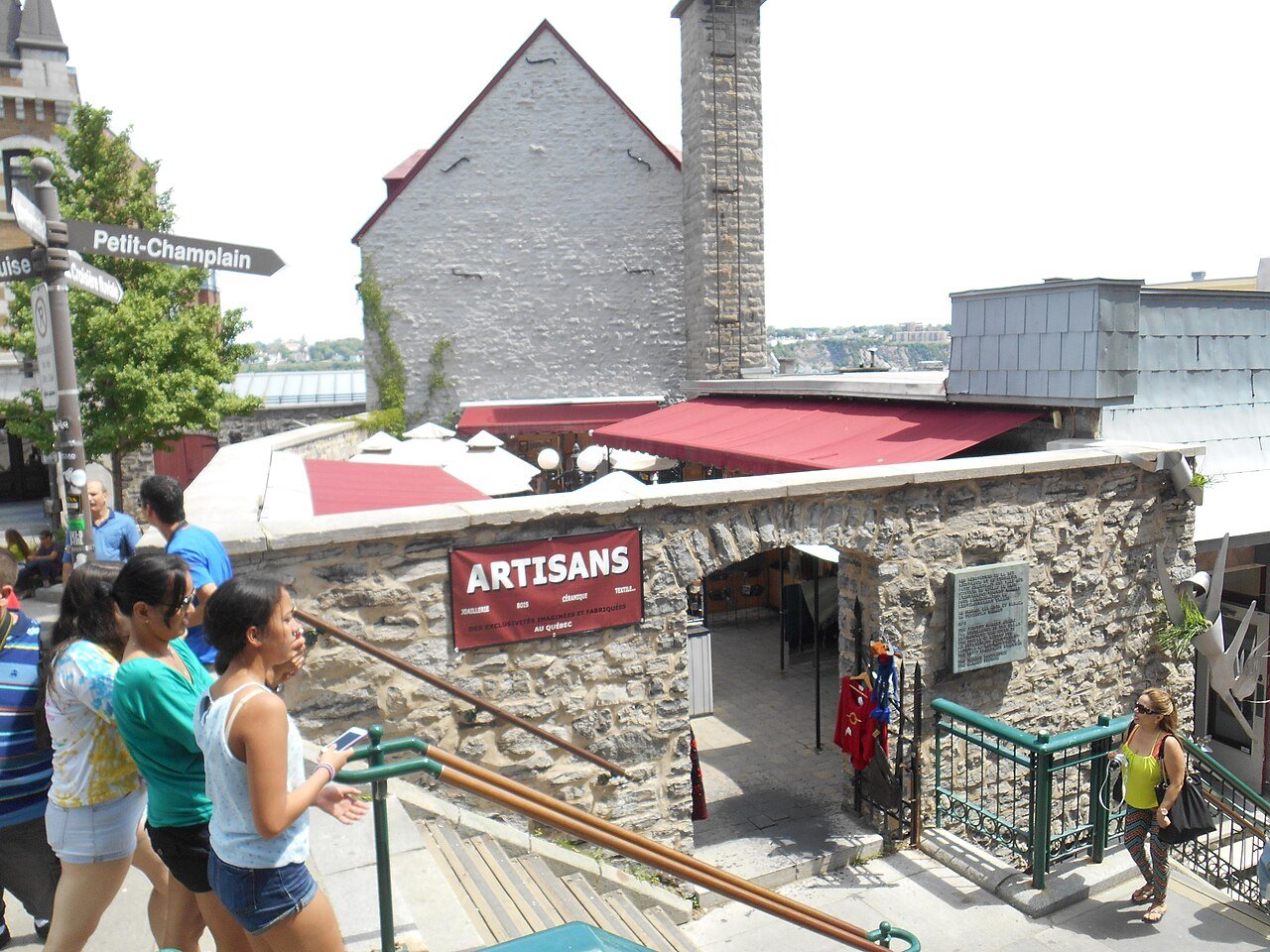 The Breakneck Steps (Escalier Casse-Cou) descending into the Quartier Petit-Champlain with stone buildings and an artisans sign