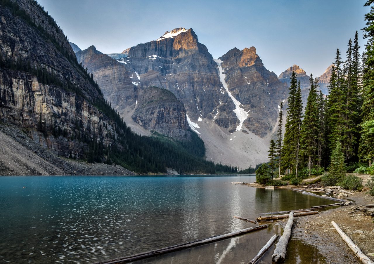 Turquoise Moraine Lake beneath the Valley of the Ten Peaks on a calm summer morning