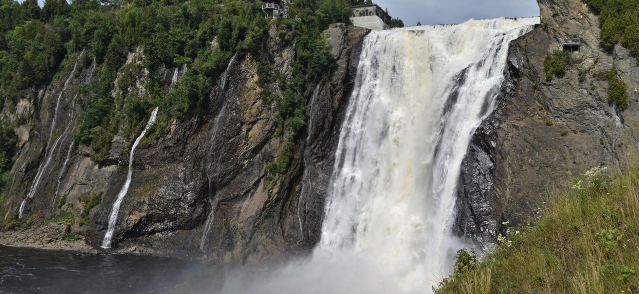 Montmorency Falls thundering down a cliff face, at 83 metres taller than Niagara Falls
