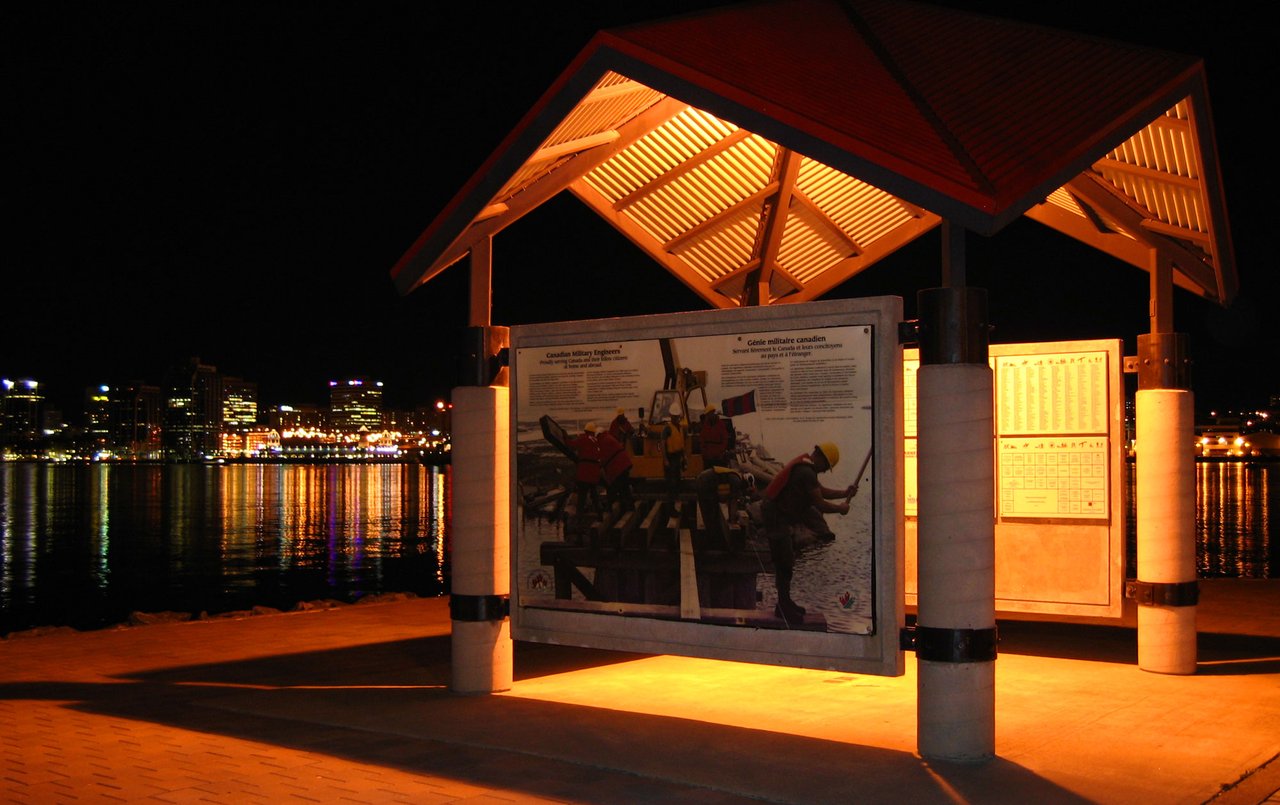 Quiet boardwalk scene along the Dartmouth waterfront with boats and the harbour