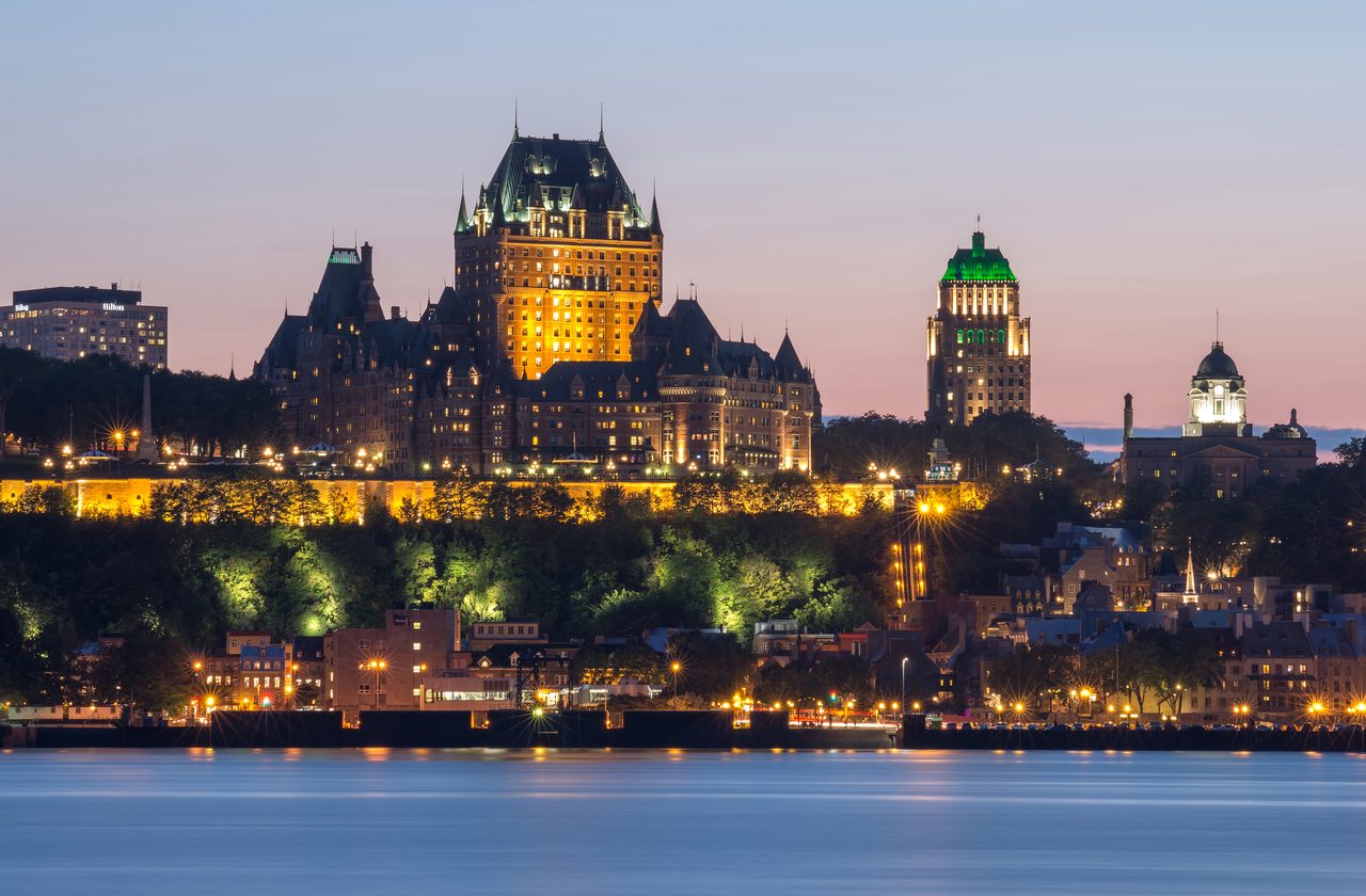 Quebec City lit up at night, viewed across the river from Lévis