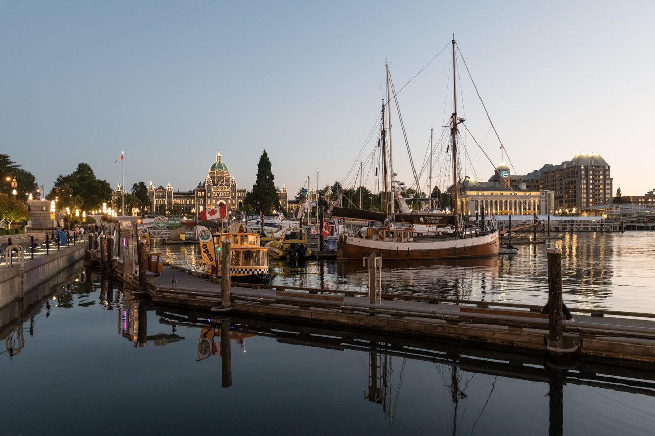Victoria's Inner Harbour at dusk with the lit British Columbia Parliament Buildings