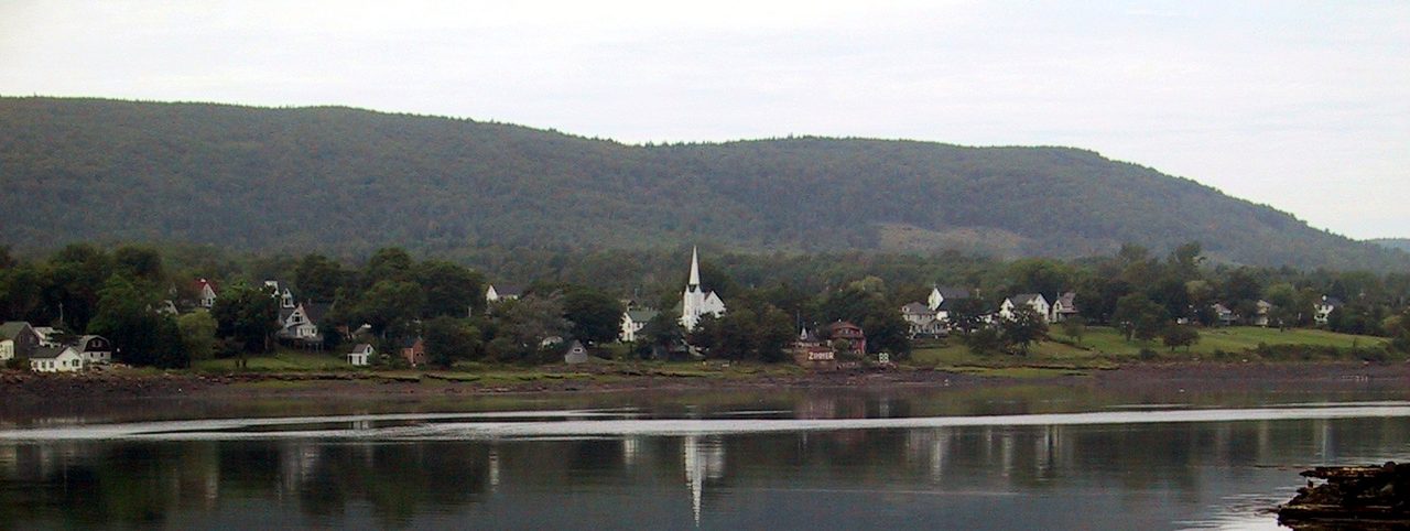 Historic rooftops and church spires of Annapolis Royal seen from across the water