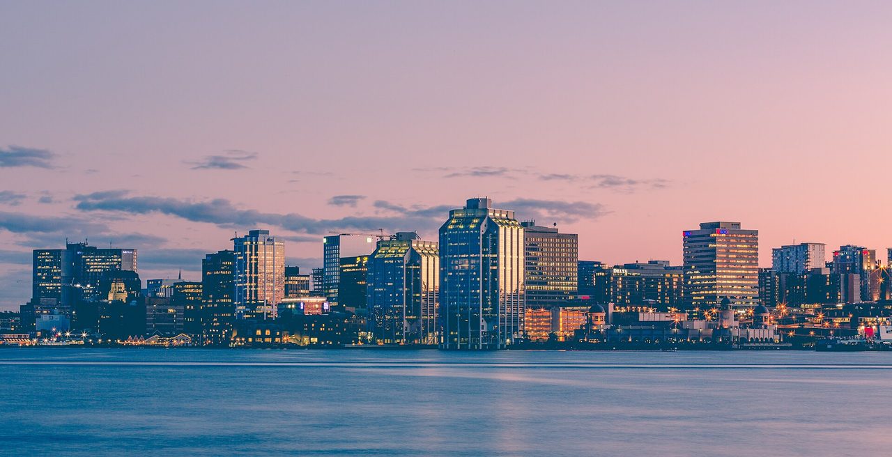 Halifax harbour skyline glowing pink and gold at sunset over the water