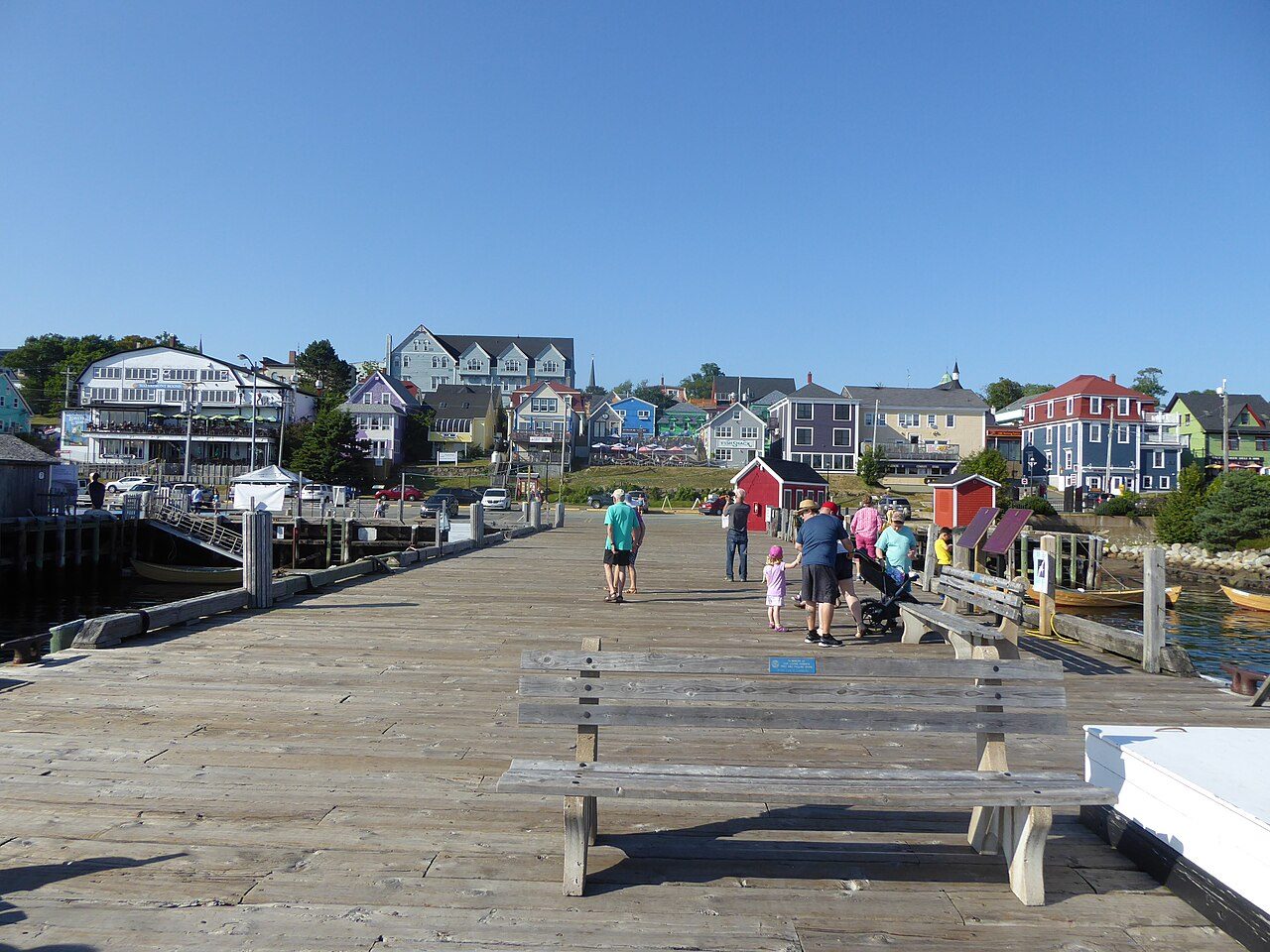 Wooden boardwalk and wharf in front of Lunenburg's colourful historic houses