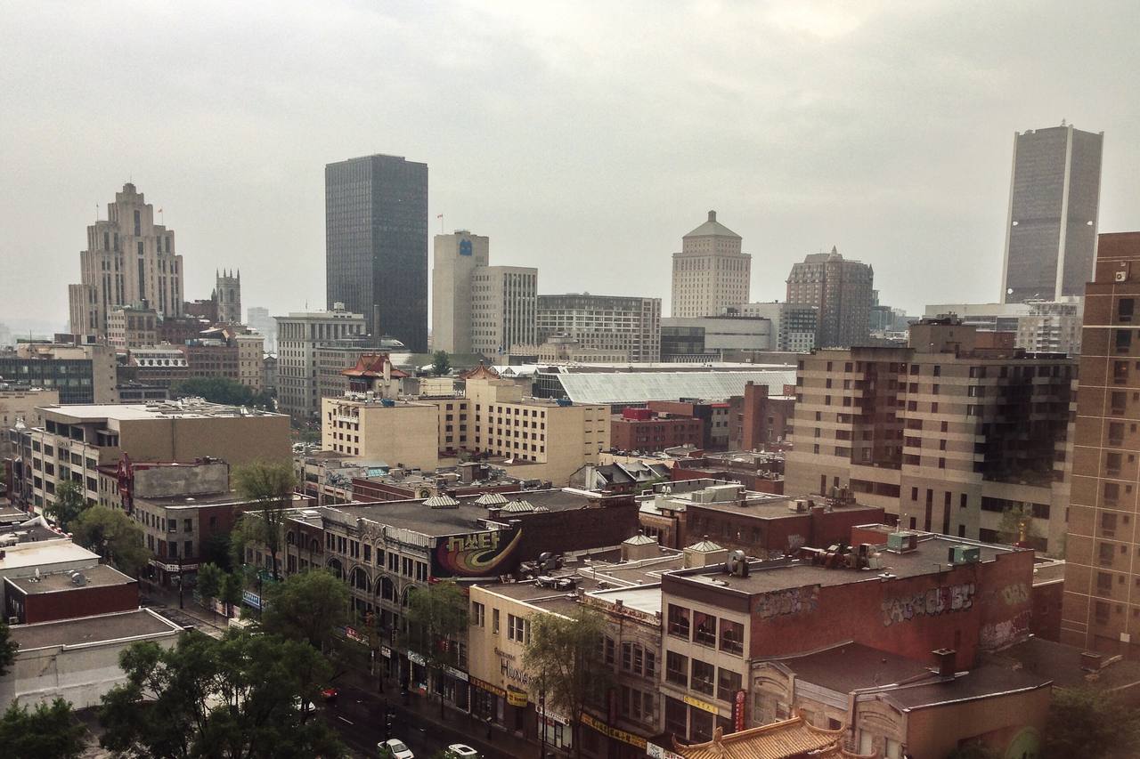 Old Montreal skyline at dusk with Notre-Dame Basilica's towers and the Old Port along the St. Lawrence River