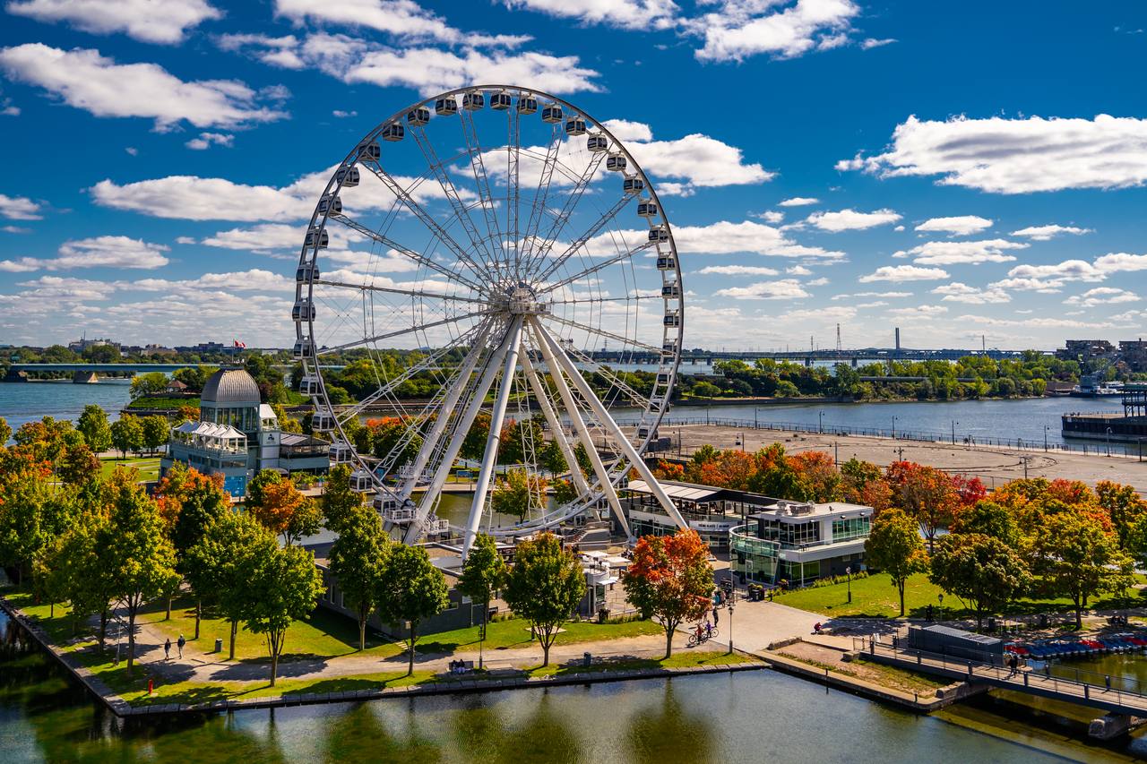 The Montreal Observation Wheel ferris wheel glowing at the Old Port on the St. Lawrence River
