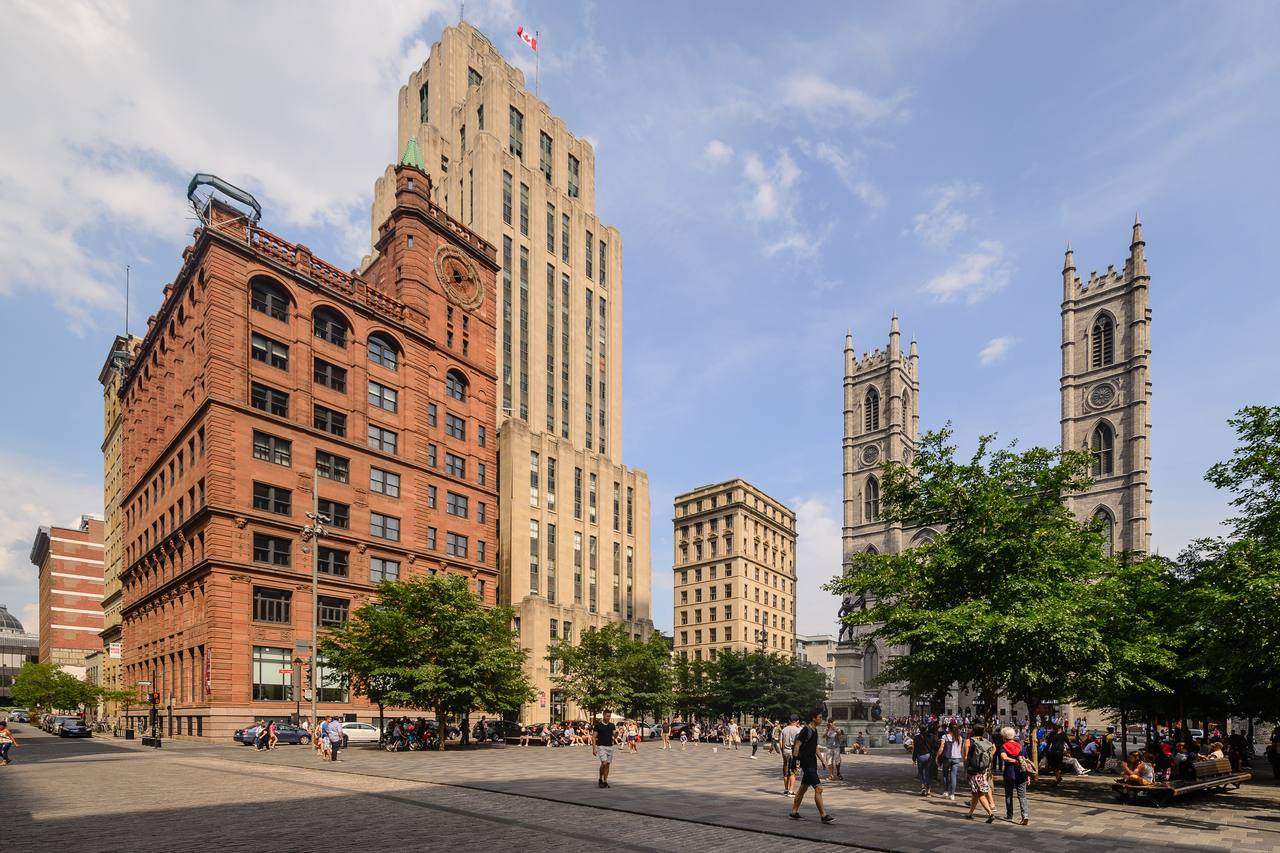 Place d'Armes square in Old Montreal with historic buildings and the Maisonneuve monument