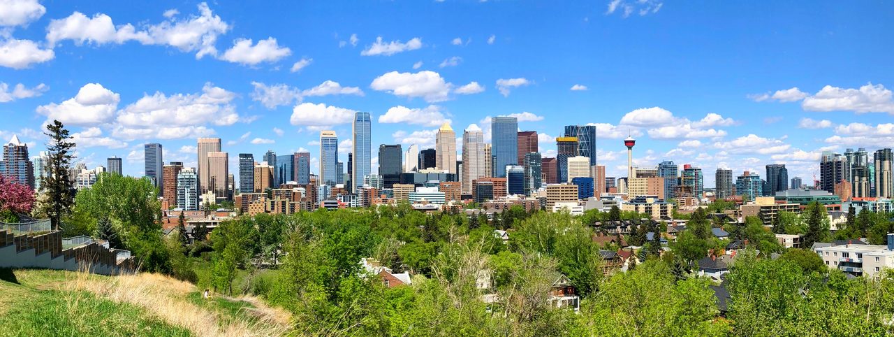 Calgary downtown skyline of glass towers against a prairie sky