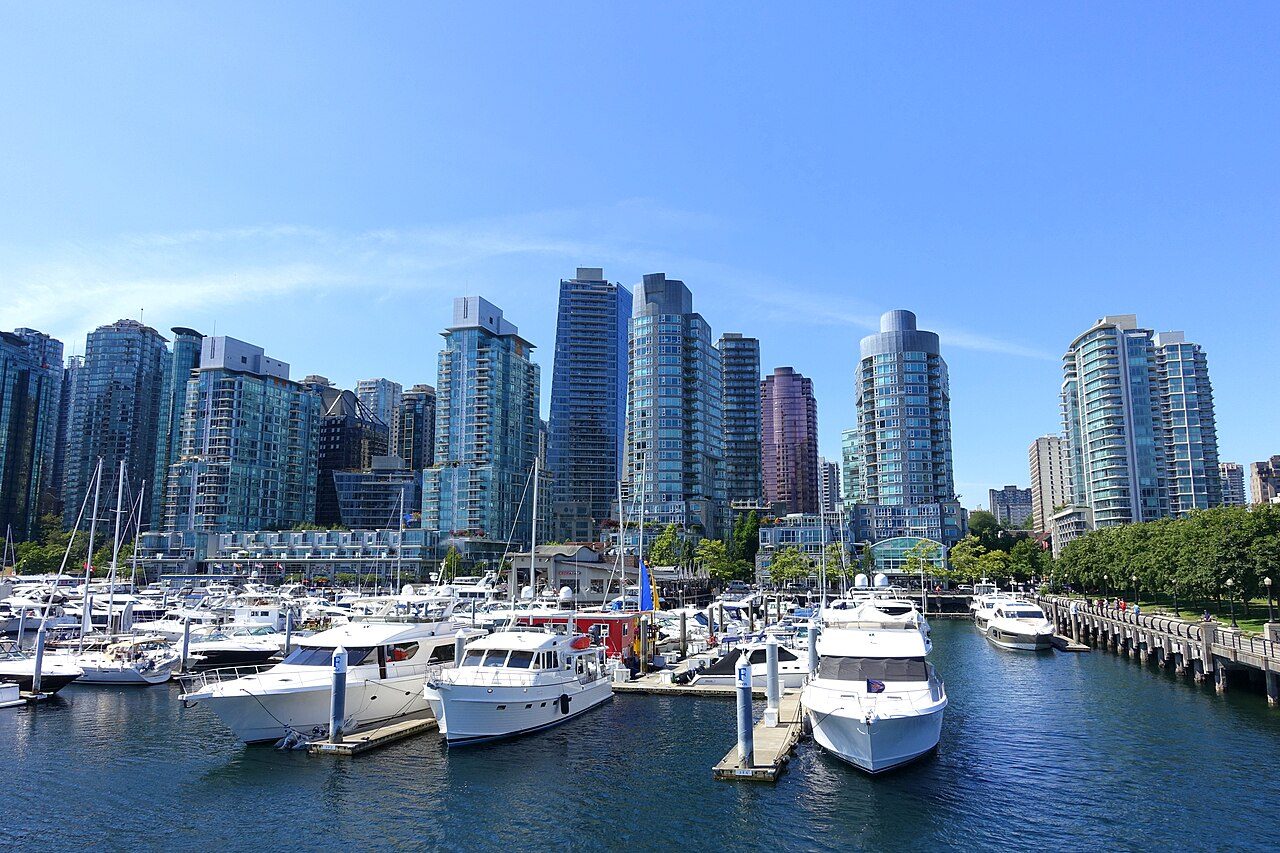 Vancouver skyline with marina and North Shore mountains rising behind the downtown towers