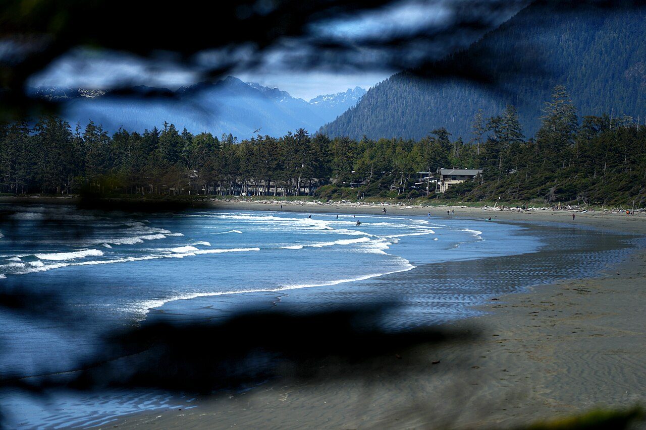 Waves rolling onto Long Beach near Tofino with sea stacks in the distance