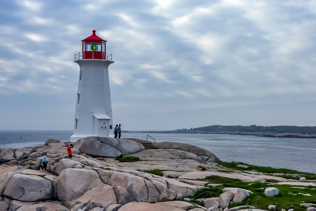 Peggy's Cove lighthouse standing on granite rocks overlooking the Atlantic Ocean in Nova Scotia