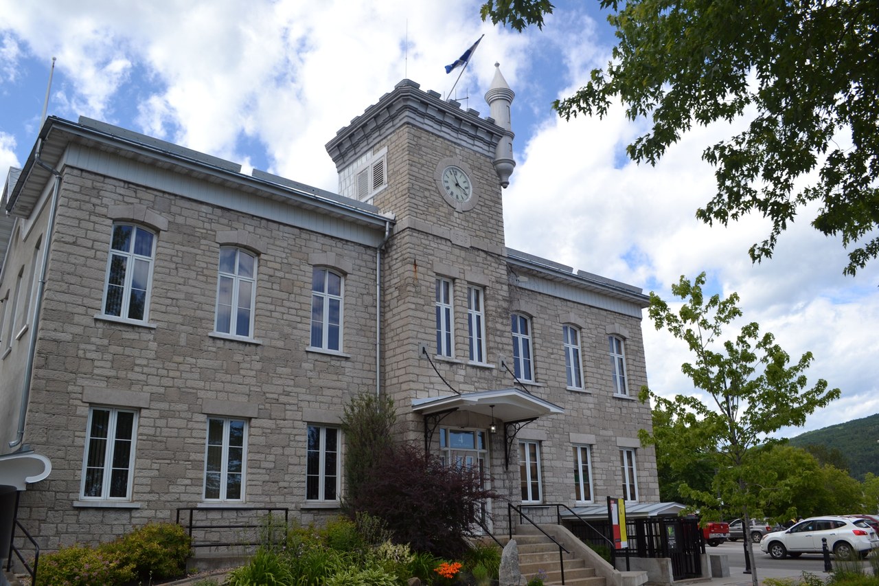 The stone MRC de Charlevoix building under blue sky in Baie-Saint-Paul