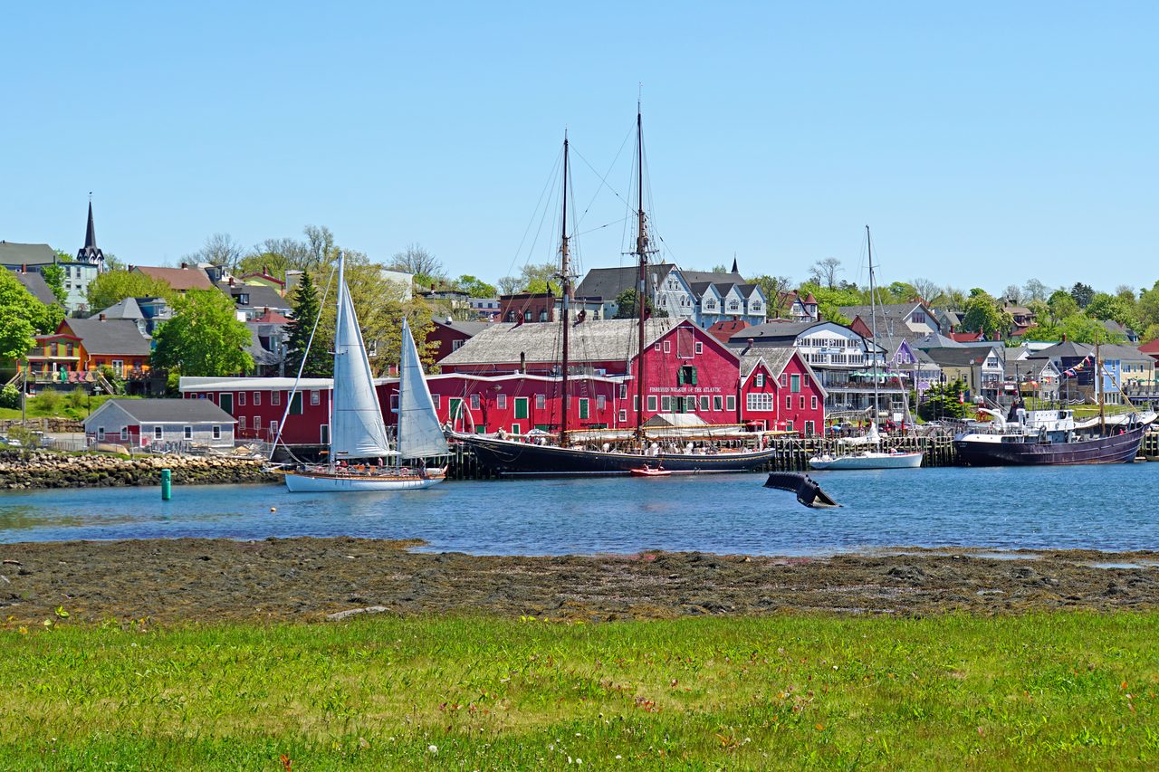 Boats leaving Lunenburg harbour with the colourful historic waterfront behind them
