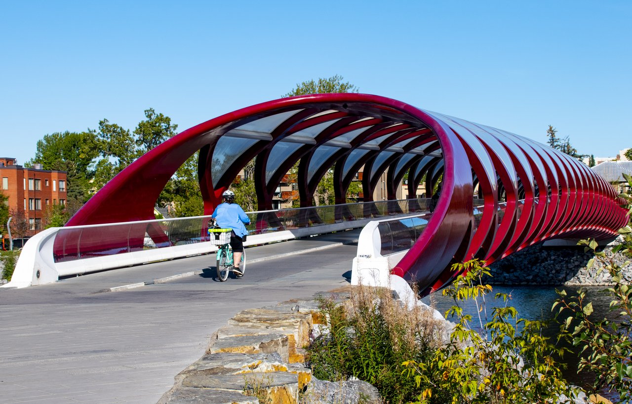 The red Peace Bridge arching over the Bow River in Calgary, designed by Santiago Calatrava