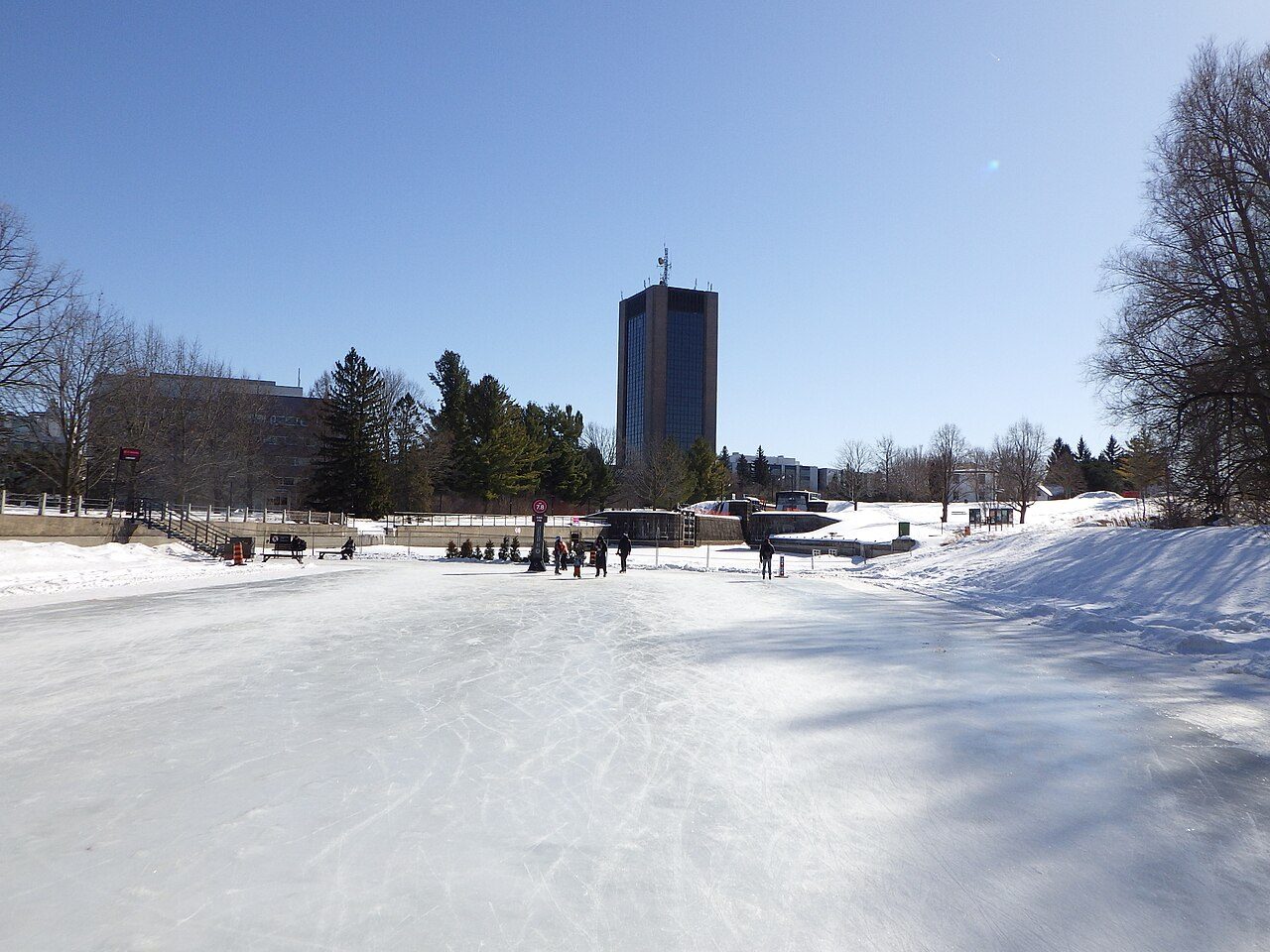 Skaters gliding along the frozen Rideau Canal Skateway in Ottawa in winter