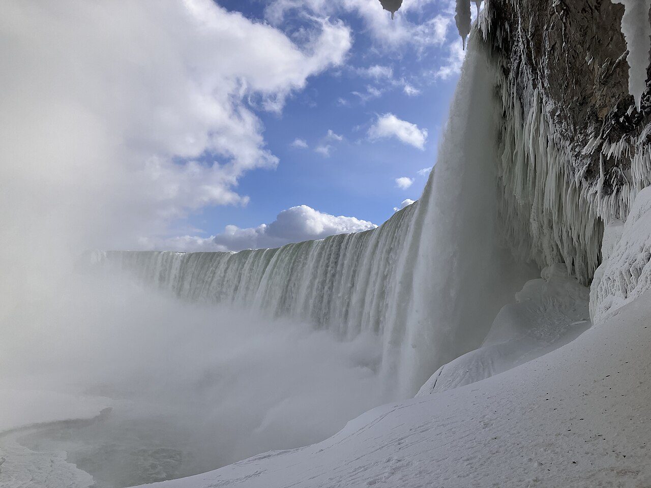 Niagara Falls in winter with ice and frost surrounding the cascades