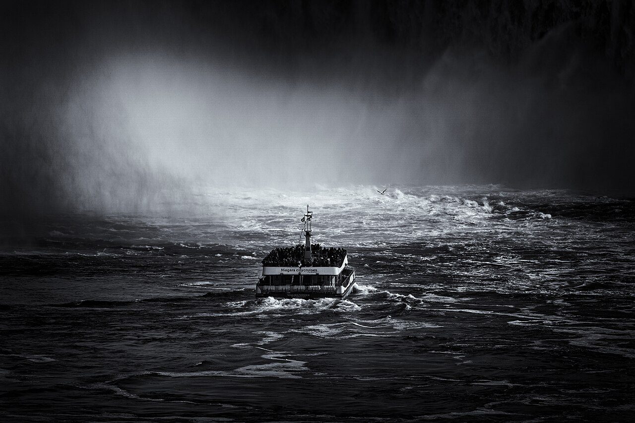 Hornblower cruise boat approaching the mist of Horseshoe Falls at Niagara Falls