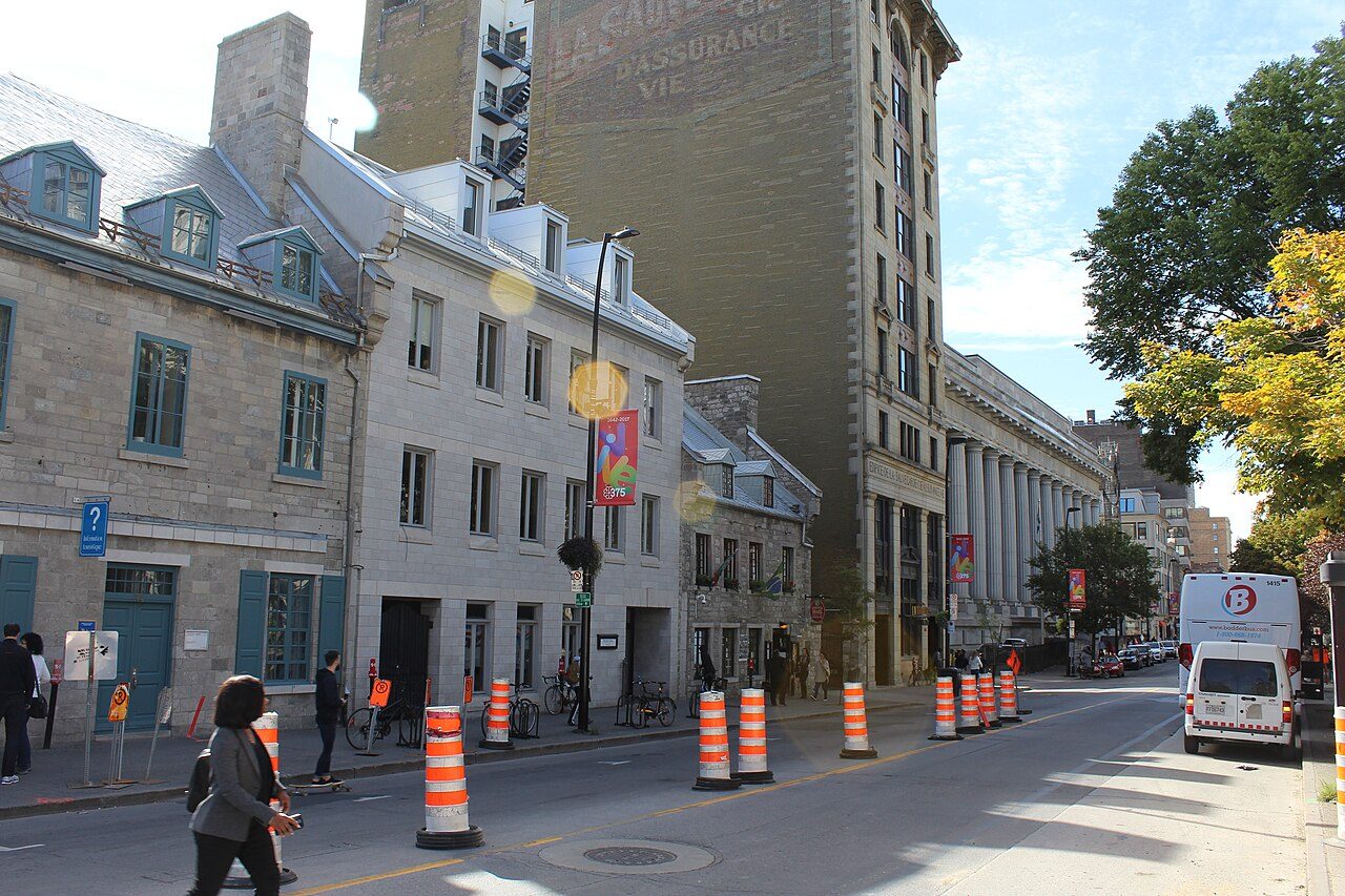 Cobblestone Rue Notre-Dame in Old Montreal with historic stone buildings