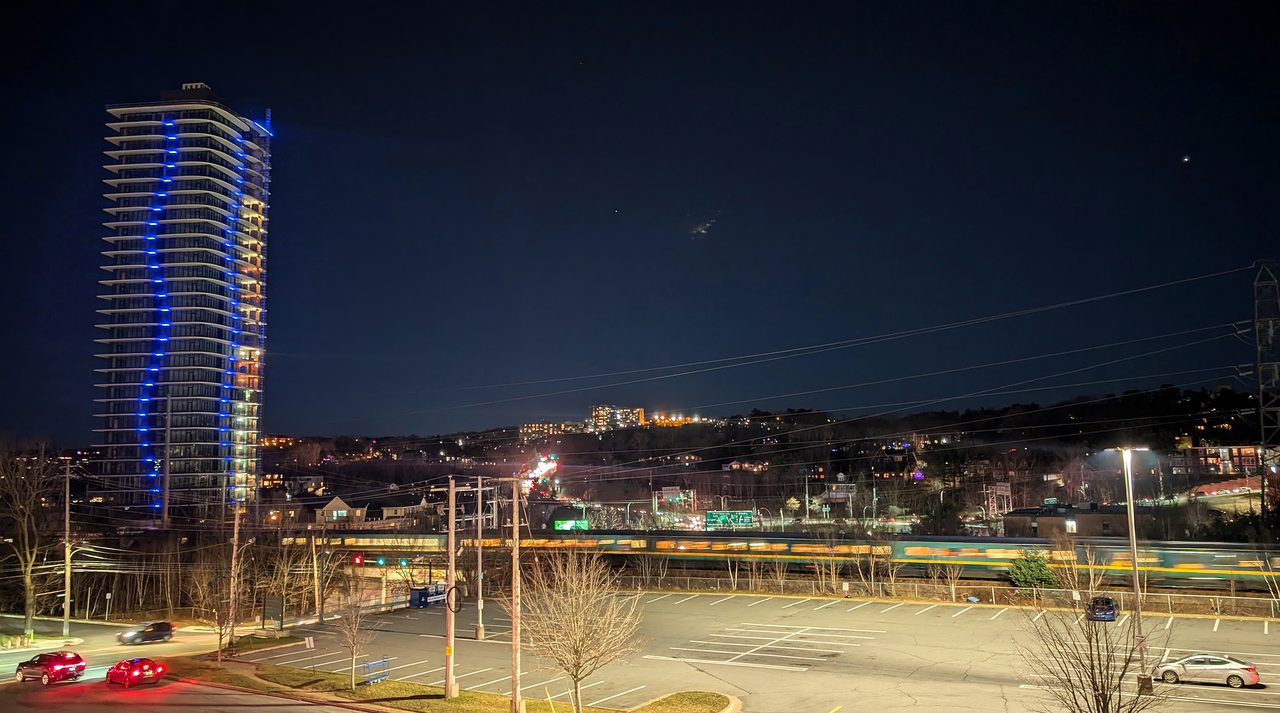 VIA Rail's The Ocean train rolling through Halifax with city waterfront beyond