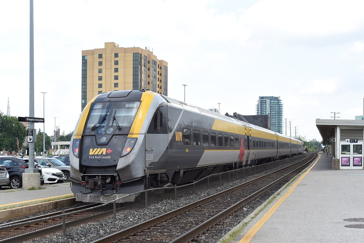 A VIA Rail passenger train stopped at a station platform in Brampton, Ontario