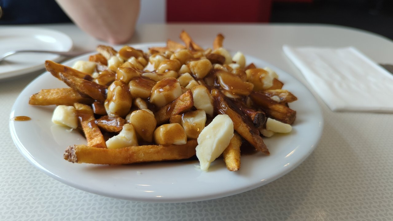 A dish of poutine topped with cheese curds and gravy, served in Windsor, Ontario