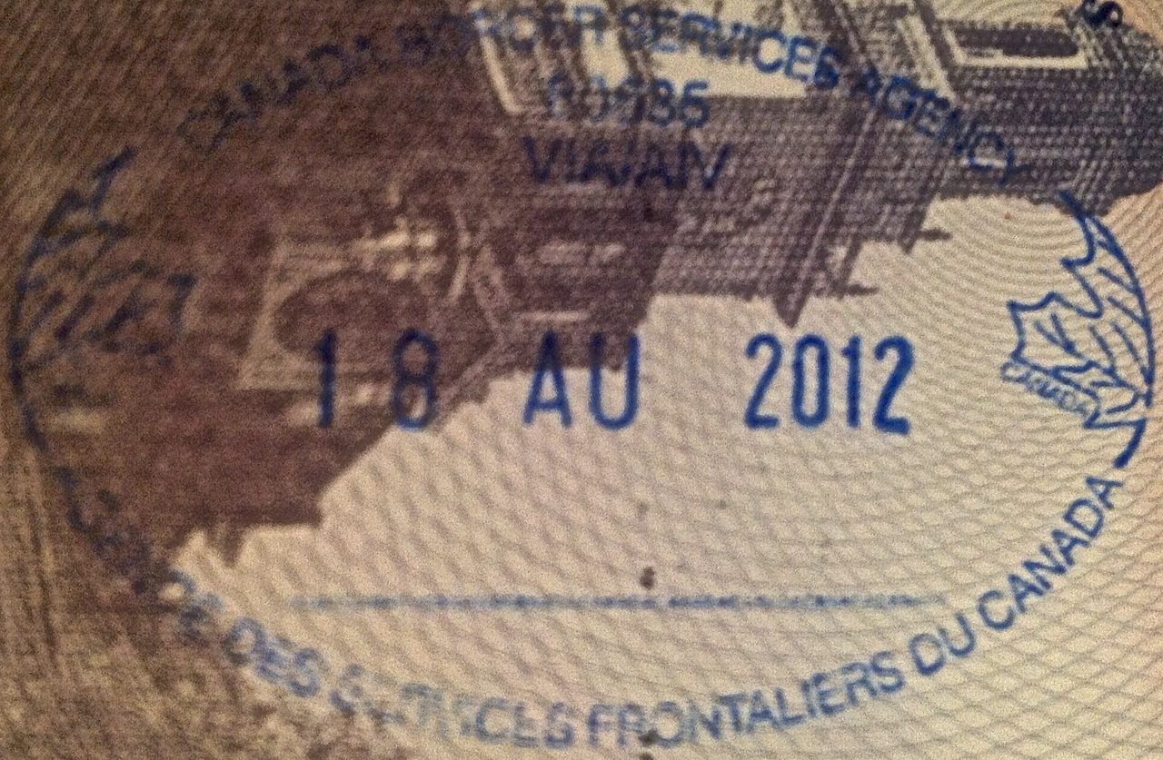 Close-up of a Canada entry stamp on a passport page