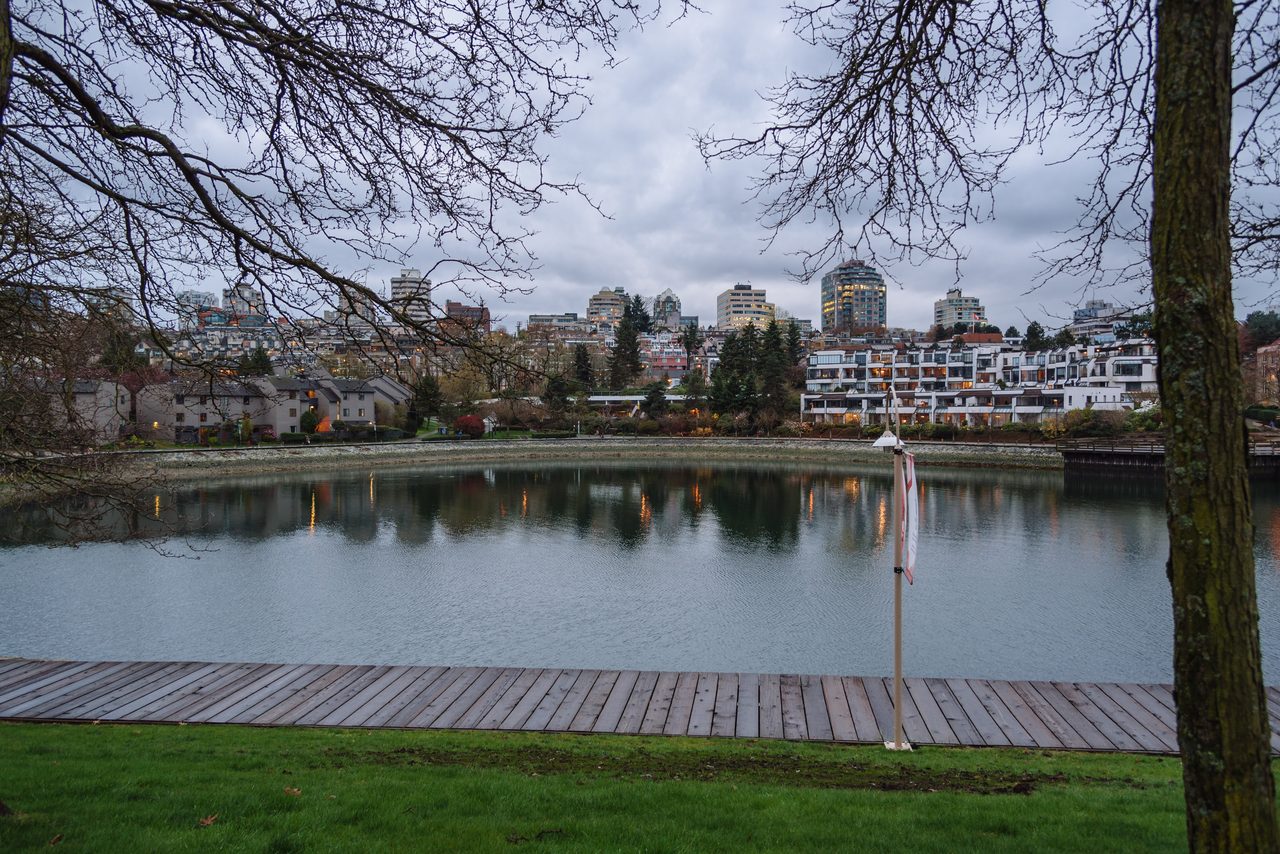 Vancouver skyline with glass towers and mountains rising in the distance