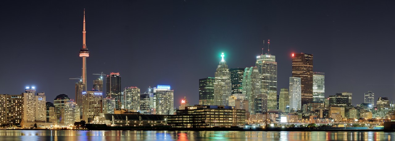 Toronto skyline at dusk with the CN Tower lit above Lake Ontario