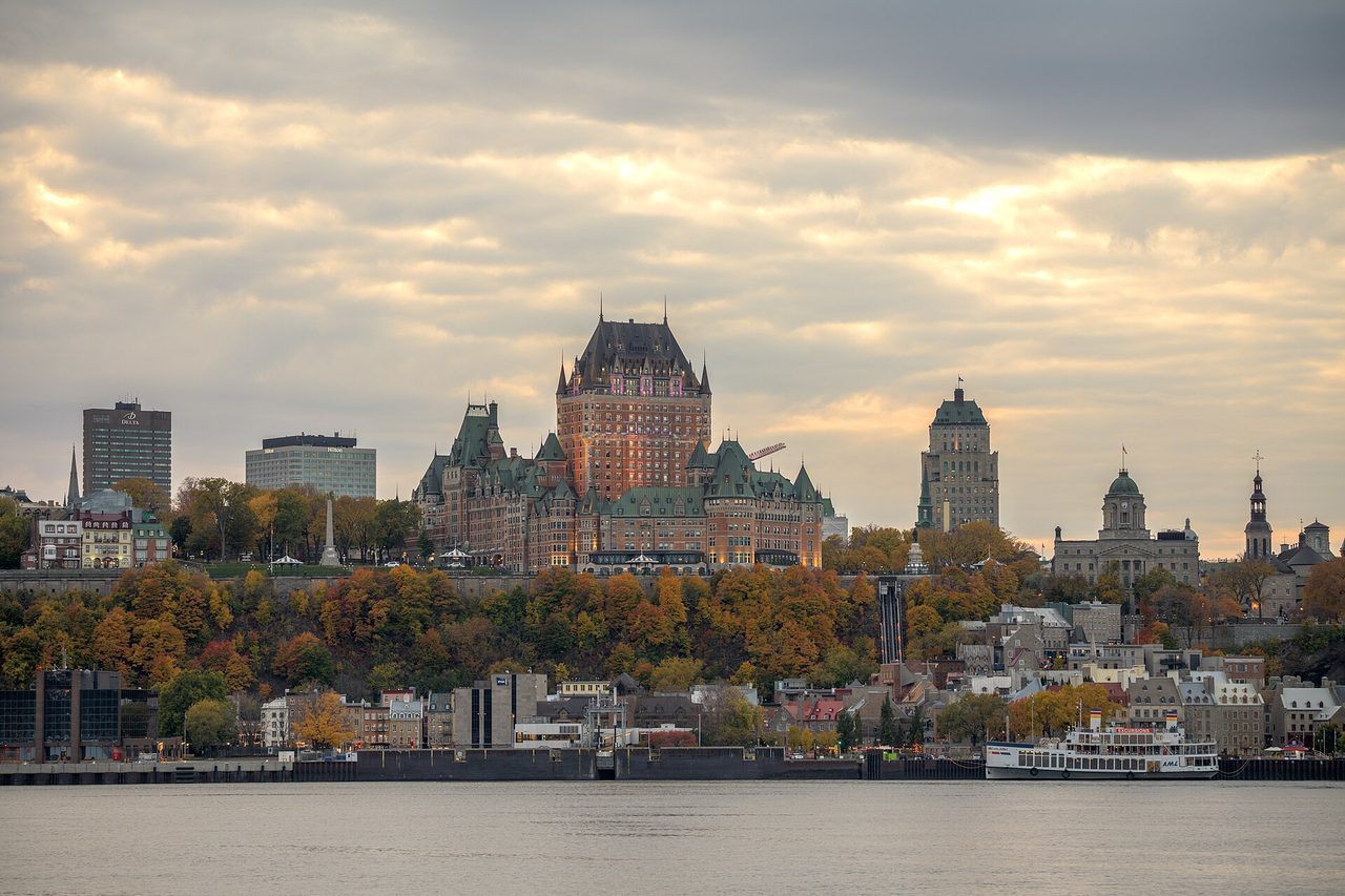 Autumn foliage framing historic rooftops in Old Quebec City